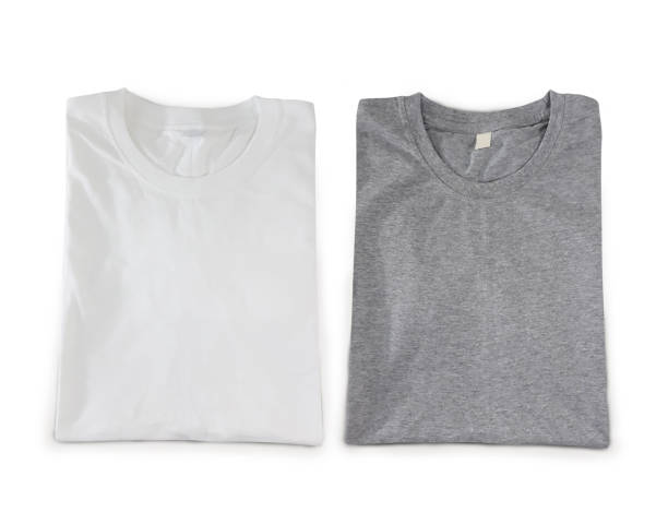 Folded T-shirts di cut on white background. Heather grey and white color. Folded T-shirts di cut on white background. Heather grey and white color. With clipping path at t-shirts shape and shadow for retouching. Ready for add graphics on. heather grey stock pictures, royalty-free photos & images