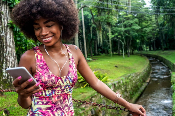 istock young woman taking a break from training and using her smartphone 1155684684