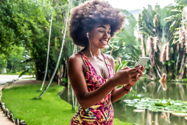 istock young woman taking a break from training and using her smartphone 1155684829