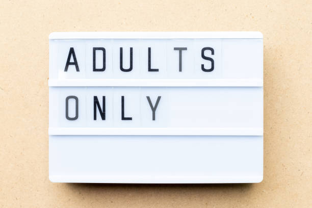 istock White lightbox with word adults only on wood background 1155684850