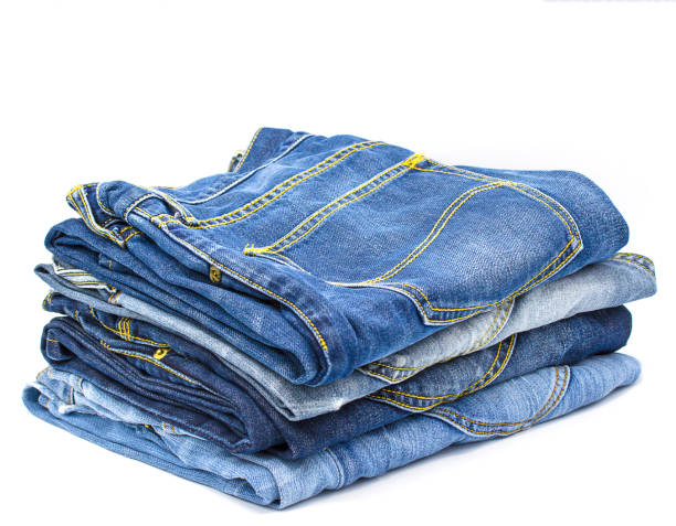 istock Jeans stacked  on white background with copy space.Closeup. 1155690233