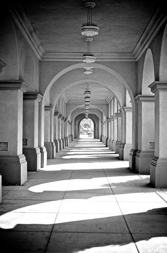 Black and white arched hallway with shadows
