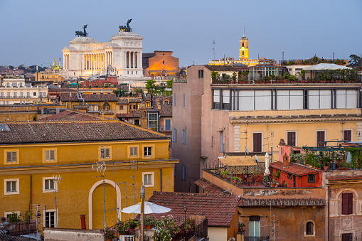 Rome, Italy, Jun 12 - A warm light of a spring sunset illuminates the roofs of Rome near Piazza Campo dei Fiori. On the bottom the white silhouette of the Altare della Patria (Altar of the Fatherland), the Italian National Monument dedicated to King Vittorio Emanuele II and the soldiers who died in the World Wars. Picture take in HD