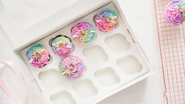 istock Boxing unicorn chocolate cupcakes into a white cupcake box. 1155699231