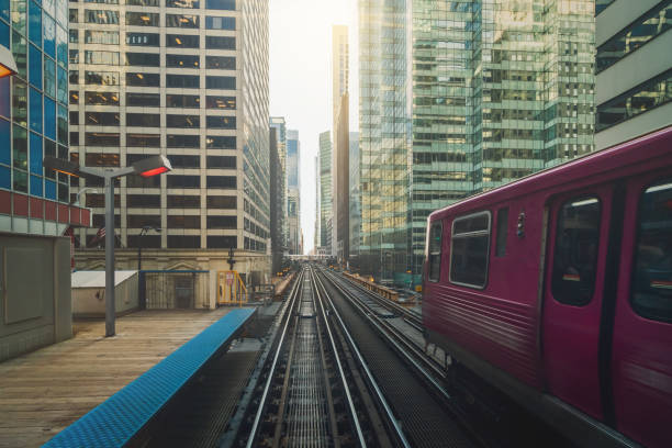 istock Elevated Train Tracks are running above the Railroad tracks between the building at the Loop line at Chicago, Illinois, USA 1155700148