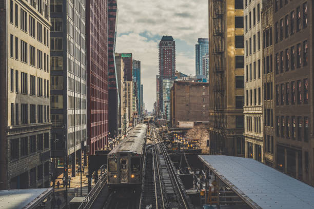 istock Elevated Train Tracks are running above the Railroad tracks between the building at the Loop line at Chicago, Illinois, USA 1155700155