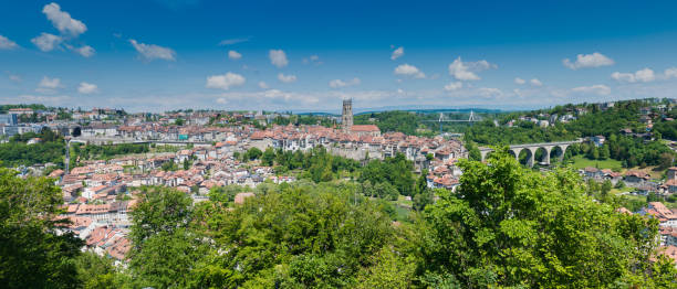 panorama view of the historic Swiss city of Fribourg with its old town and many bridges and cathedral A panorama view of the historic Swiss city of Fribourg with its old town and many bridges and cathedral fribourg city switzerland stock pictures, royalty-free photos & images