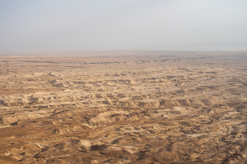 Sand dunes against the sky. Beautiful desert landscape. Desert close-up. udean desert located on the West Bank of the Jordan river. Deserted shore of dead sea. The background of desert. barren land