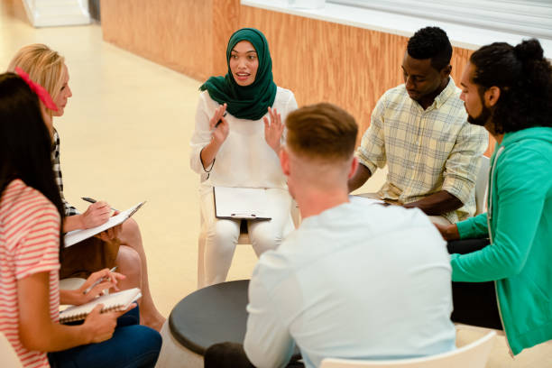 istock Business people sitting together and having a group discussion in a modern office 1155701249