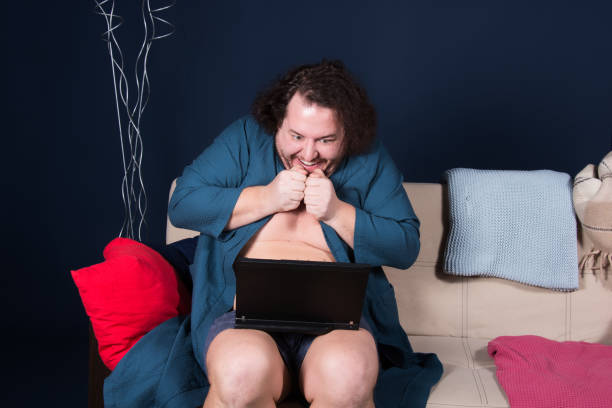 istock Online date. Funny fat man. 1155704256