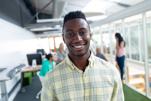 istock Businessman looking at camera in a modern office 1155705799