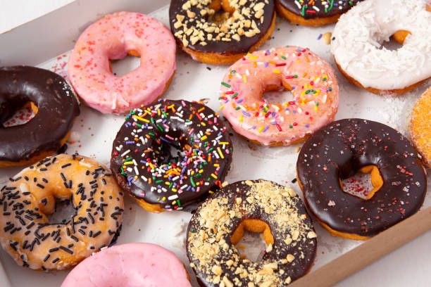 istock Freshly baked donuts in a cardboard container 1155706086