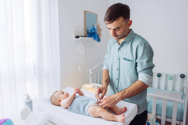 istock Changing diaper to baby son 1155706422