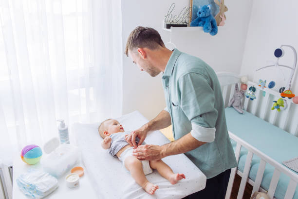 istock Changing diaper to baby son 1155707181