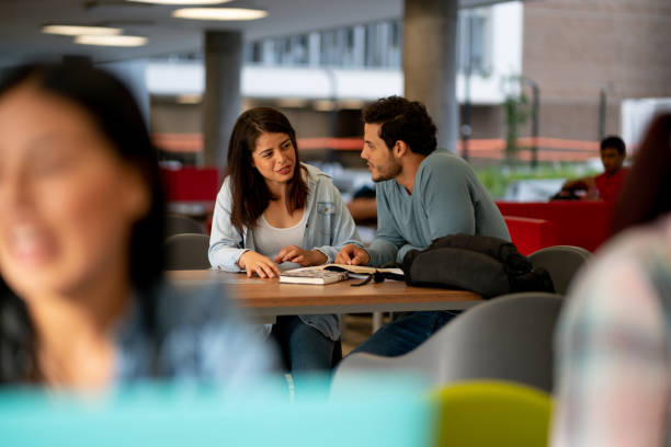 istock University friends studying together talking and smiling 1155707619