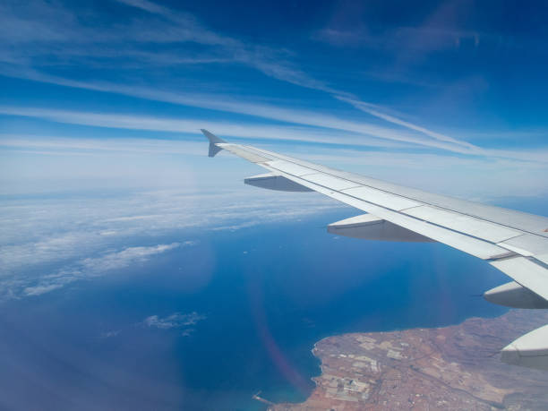 istock from the inside, through the window of a commercial airplane 1155710487