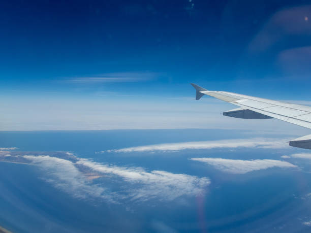 istock from the inside, through the window of a commercial airplane 1155710488