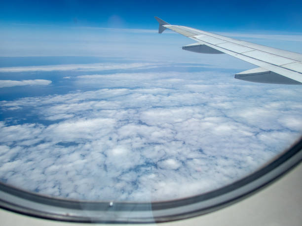 istock from the inside, through the window of a commercial airplane 1155710511