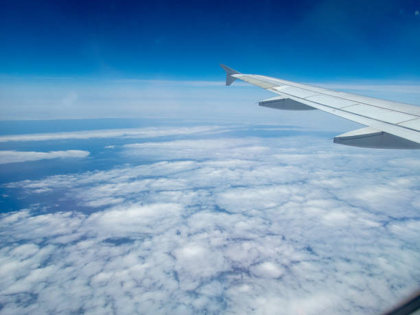 istock from the inside, through the window of a commercial airplane 1155710559