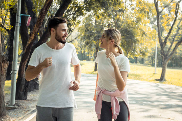 istock Couples exercise at the park in the morning. 1155714994