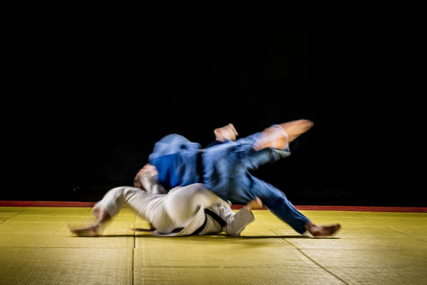 istock Blurred judo practitioners struggling on the ground 1155720771