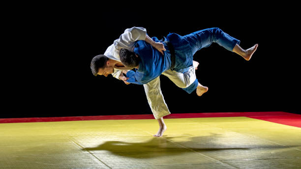 judoka jetant son partenaire au sol - judo photos et images de collection