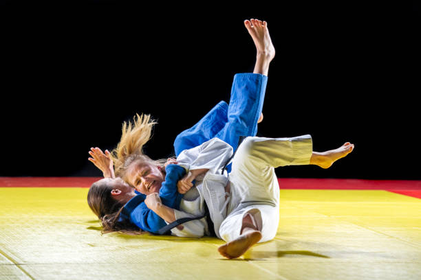 istock Two female judokas wrestling on the ground 1155720807