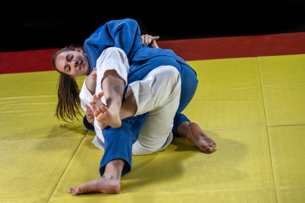istock Two female judokas fighting on the ground 1155720823