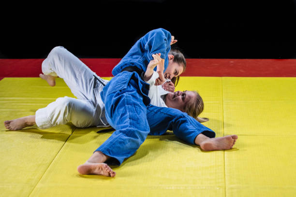 istock Two female judokas fighting on the ground 1155720827