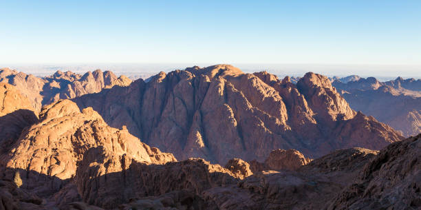 istock Beautiful view from the mountain. Panorama. Mountain range with visible silhouettes through the morning blue fog 1155721532