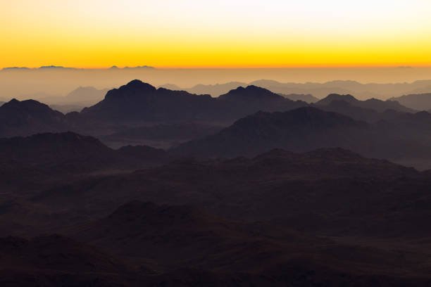 istock Beautiful view from the mountain. Panorama. Mountain range with visible silhouettes through the morning blue fog 1155721610
