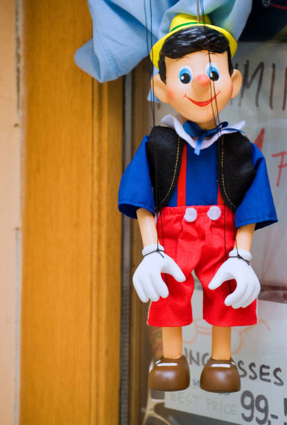 Wooden marionette hanging in front of the shop - Pinocchio