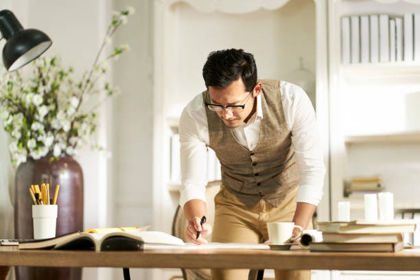 istock asian architet working in home office 1155722140