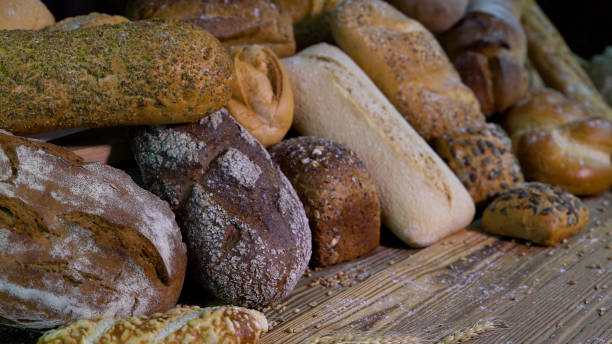 istock The range of bread on the table from the old boards. 1155722794