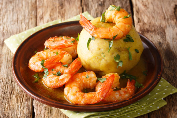 istock Latino american main course mofongo with shrimps and broth close-up on a plate. horizontal 1155723704