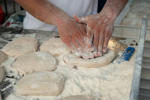 istock Preparing Pizza dought at the pizzeria. 1155724606
