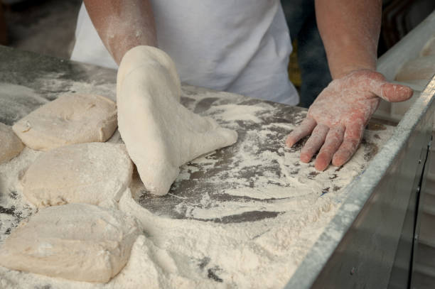 istock Preparing Pizza dought at the pizzeria. 1155724628