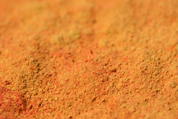 istock orange powder pigment art texture background 1155725183