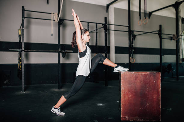 istock Young sporty woman stretching in interior before exercise 1155727493