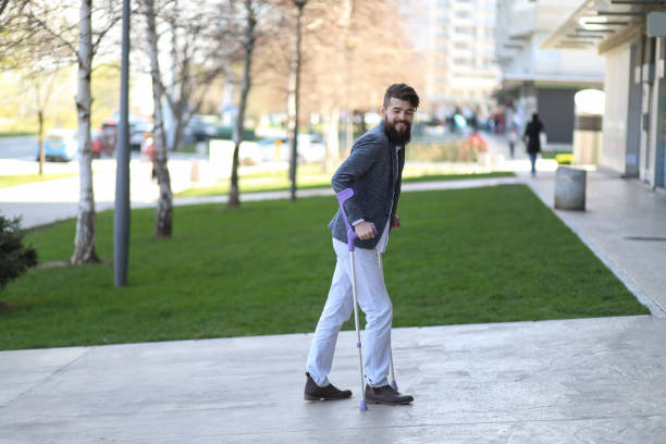 istock Young man with walking sticks outdoors 1155730938