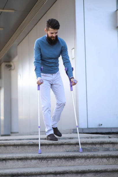 istock Young man with walking sticks outdoors 1155730993