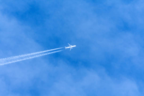 istock Contrail in the sky higher than clouds left by commercial liner. 1155733984