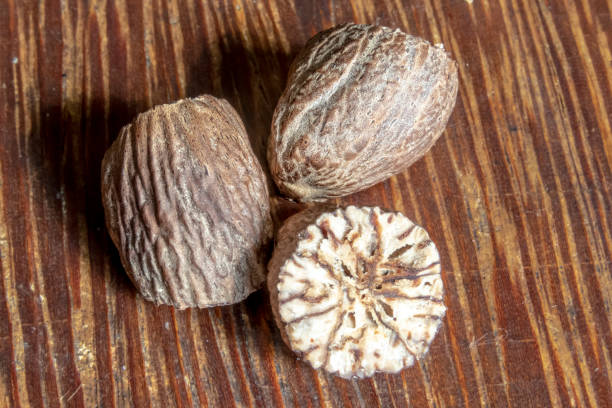 istock nutmeg spice isolated on the wooden background 1155734069
