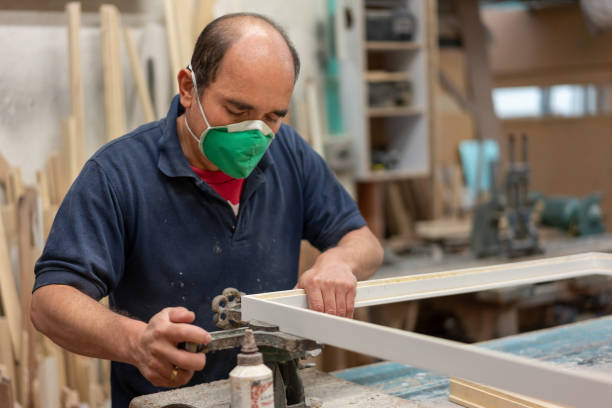 istock Portrait of a carpenter making a wood frame 1155739047