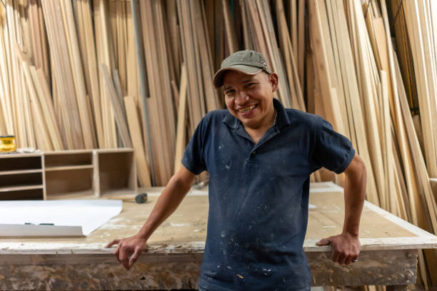 istock Happy carpenter working at the workshop and smiling 1155739087