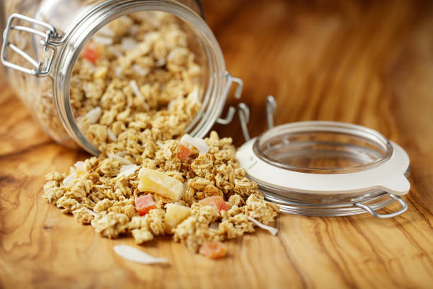 close up view of home made fruit granola in glass jar