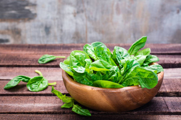 istock Fresh baby spinach leaves in a bowl 1155742457