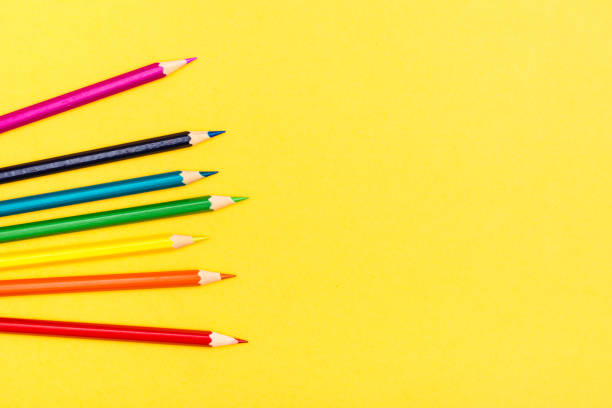 istock Colored wooden pencils on a yellow background. Rainbow palette 1155742629