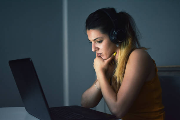 istock A woman working on a laptop at night at home 1155742673