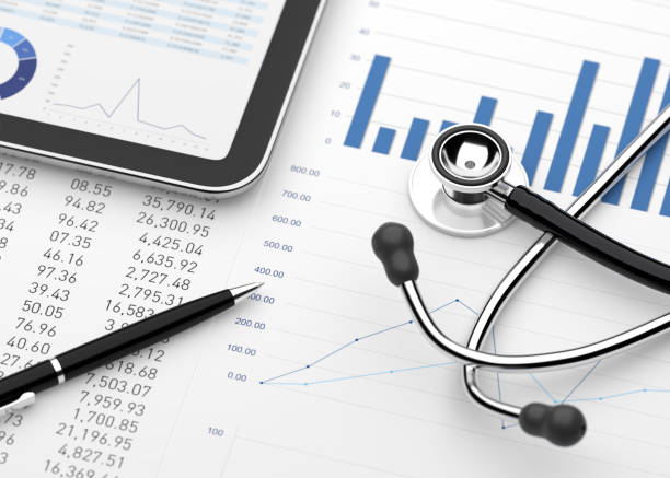 Stethoscope with financial statement digital tablet stock photo